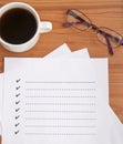 blank checklist with glasses and coffee