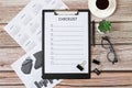 Blank Checklist on wooden desk with coffee, glasses, calendar, plants