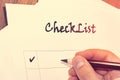 blank checklist on wooden table A sheet of paper in front of a man with the words: Check List . Planning of affairs for the day. C