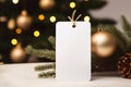 Blank christmas gift tag on blurred christmas tree background with bokeh Royalty Free Stock Photo