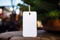 Blank christmas gift tag on blurred christmas tree background with bokeh Royalty Free Stock Photo