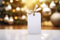 Blank christmas gift tag on blurred christmas tree background with bokeh Royalty Free Stock Photo