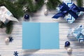 Blank Christmas greeting card, template on blue wooden background with presents. Mockup Royalty Free Stock Photo