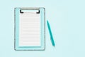 Blank clipboard mockup and ballpoint pen on light blue color background. Top view, copy space. Back to school, deadline, morning Royalty Free Stock Photo