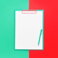 Blank clipboard mockup and ballpoint pen on red-green color background. Back to school, deadline, morning concept. Top view, copy Royalty Free Stock Photo