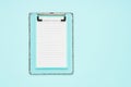 Blank clipboard mockup on light blue color background. Back to school, deadline, morning concept. Top view, copy space Royalty Free Stock Photo