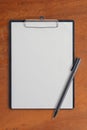 Blank clipboard and pen on Wood Table Royalty Free Stock Photo