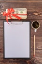 Blank clipboard with pencil, cup of tea and money gift. Royalty Free Stock Photo