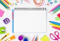 Blank notebook with school supplies frame against a white background with copy space. Back to school. Royalty Free Stock Photo