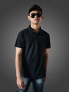 Blank collared shirt mock up template, front view, Asian male teenage model wearing plain black t-shirt. Polo tee design mockup Royalty Free Stock Photo