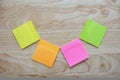 Blank colorful sticky notes on wooden surface Royalty Free Stock Photo