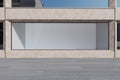 Blank contemporary outdoor showcase in concrete building. Daylit day. Mock up place for your advertisement. Shopping concept. 3D