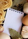 Blank cookbook with ingredients for pasta