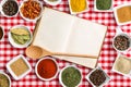 Blank cookbook and various spices.