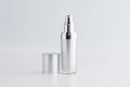 Blank cosmetic pump top silver bottle mock up on background with copy space