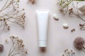 Blank Cosmetic Tube on Textured White Background with Natural Elements Royalty Free Stock Photo