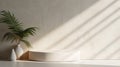 Blank cream white cement curve counter podium with texture, soft beautiful dappled sunlight, leaf shadow on white wall for luxury