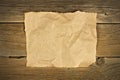 Blank crumbled brown paper on rustic wood