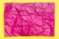 Blank crumpled purple sheet of colored paper on a yellow cardboard background. Textural motley background. Top view