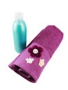 Blank cyan shampoo bottle and purple towel Royalty Free Stock Photo