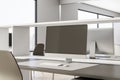 Blank dark monitor screen on brown table in modern coworking office. 3D rendering, mock up