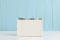 Blank desk calendar on white and blue wooden background