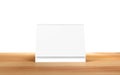 Blank desk calendar on wooden desk.