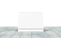 Blank desk calendar on wooden desk. Front view. Mockup template