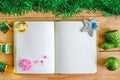 Blank diary notebook with Christmas and New Year ornaments and decoration on wooden table, green color theme Royalty Free Stock Photo