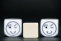 Blank dice with emoticon dice (happy, blinking) in background Royalty Free Stock Photo