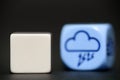 Blank dice with weather dice (thunderstorm) in background