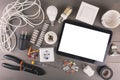 Blank digital tablet with electrical tools and equipment on wood