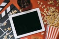 Blank digital tablet, popcorn, filmstrip, cinema and movie onlin