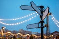 Blank directional road signs against blue sky. Black metal arrows Royalty Free Stock Photo