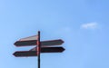 Blank directional road signs against blue sky. Black red arrows on the signpost Royalty Free Stock Photo