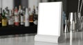 Blank display stand on a bar counter with blurry bottles and bar tools in the background Royalty Free Stock Photo