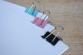 Blank document papers with colored paper clips pastel on wooden table Royalty Free Stock Photo