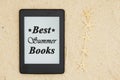 An e-reader on the beach for your summer reading with five starfish  with text Best Summer Books Royalty Free Stock Photo