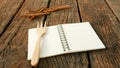 The blank earth tone note book on old dark brown wooden planks Royalty Free Stock Photo