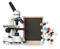 Blank, empty, black chalkboard with microscope, molecule model and DNA model over white