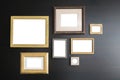 Blank empty frames on dark wooden background. Art gallery, museum exhibition white clipping path