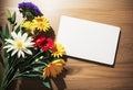 A blank empty paper card with fresh flowers