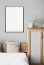 Blank empty picture frame mockup on gray wall in bedroom. Artwork in interior design. Royalty Free Stock Photo