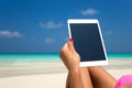 Blank empty tablet computer in the hands of women on the beach Royalty Free Stock Photo