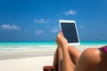Blank empty tablet computer in the hands of women on the beach Royalty Free Stock Photo