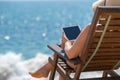 Blank empty tablet computer in the hands of women on the beach Royalty Free Stock Photo