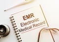 Blank with EMR or electronic medical record text on table Royalty Free Stock Photo