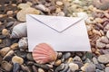 Blank envelope on the beach decorated with sea shell