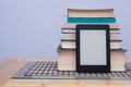 Blank eReader in front of a tower of books with bookmarks Royalty Free Stock Photo