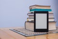 Blank eReader in front of a tower of books with bookmarks Royalty Free Stock Photo